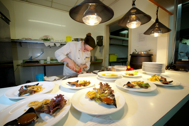 Plates Lined Up in Kitchen with student chef