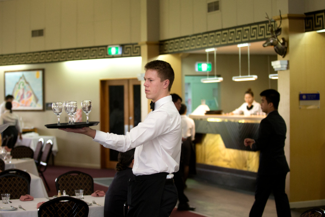 Student carrying glasses with white shirt