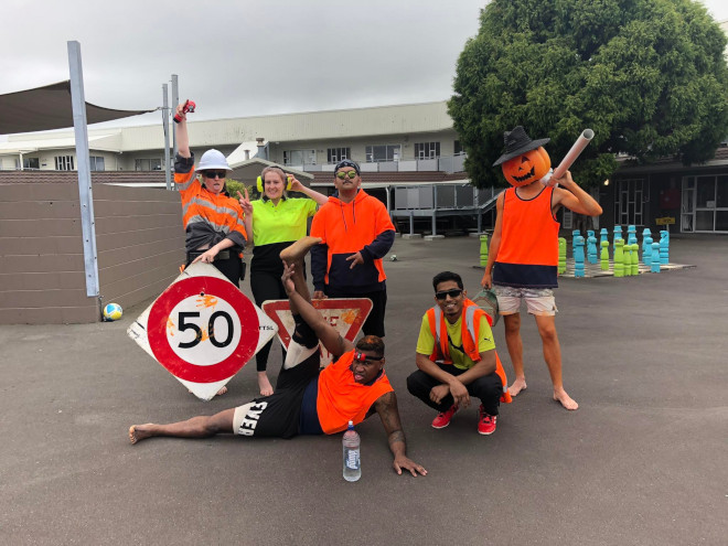 Student men at work costume with road sign