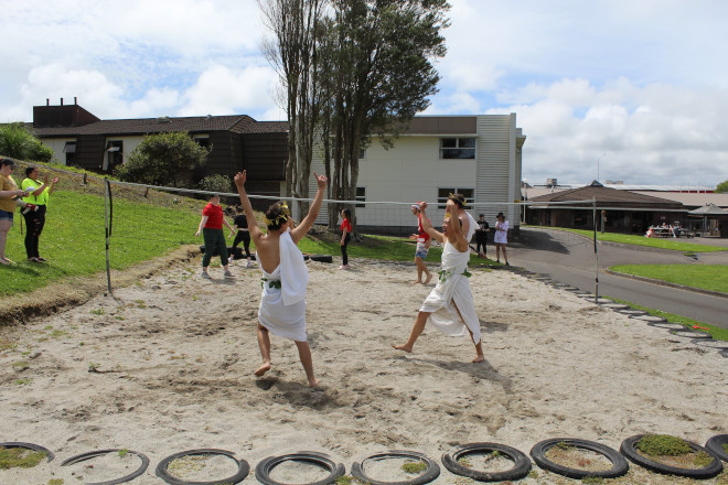 students Playing Volleyball in togas